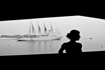 A woman posing in front of a cruise ship