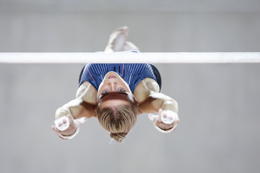 A gymnast performing a release on an apparatus