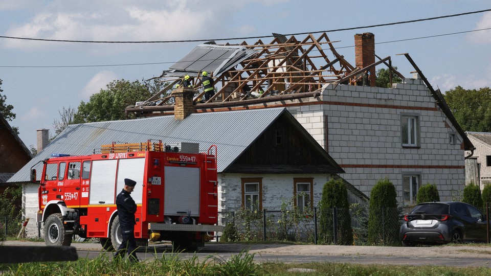 Firefighters work at a damaged home in Wyryki, a village in Poland, after Russian drones violated Poland's airspace.