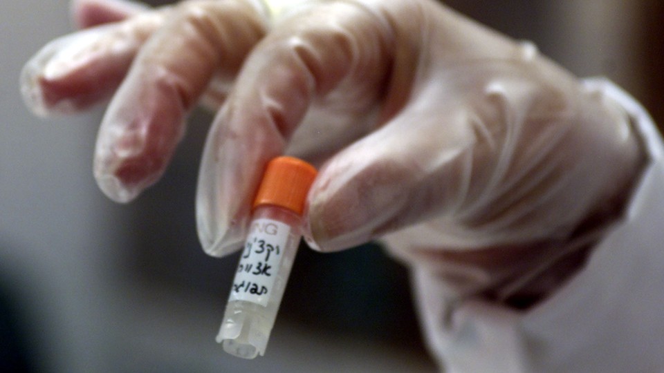 A nurse holds up a smallpox vaccine.