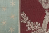 An embroidered portrait of George Washington next to the faded blue silk flag that indicated his presence on the Revolutionary War battlefield.