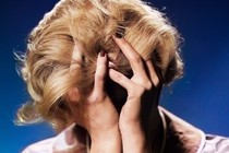 A woman with her head in her hands