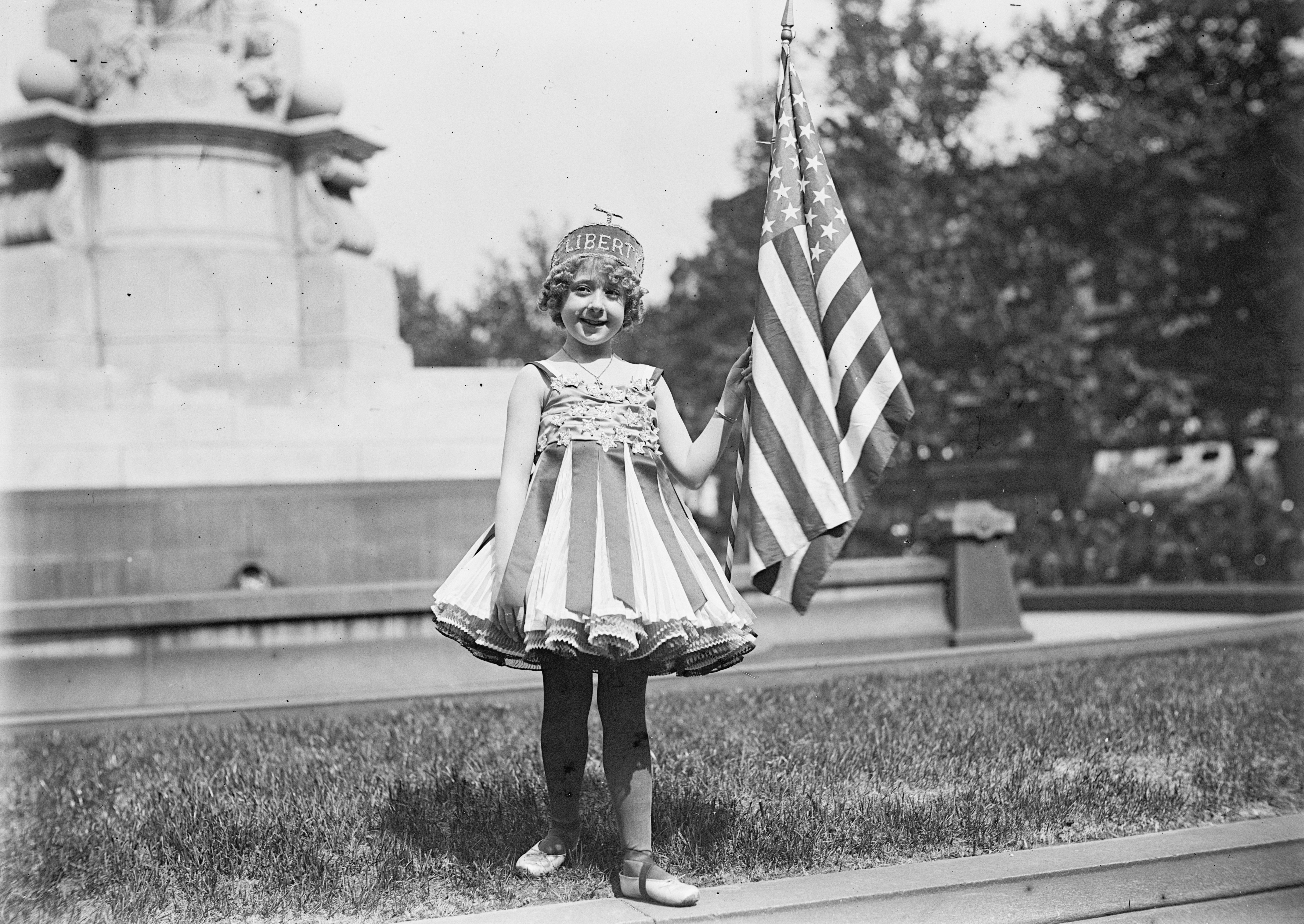A girl wearing a crown that reads