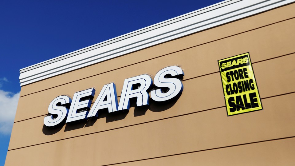 A "Store Closing Sale" sign on a Sears building