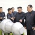 Kim Jong Un and North Korean officials examine what appears to be a missile