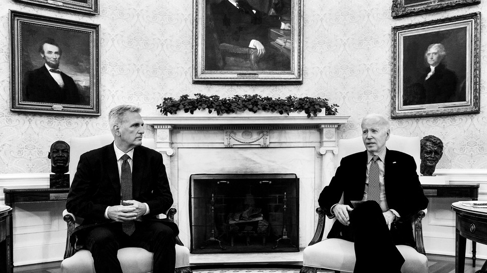 A black-and-white photo of Kevin McCarthy and Joe Biden sitting side by side