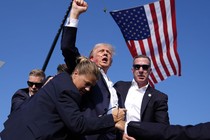 The Republican presidential candidate, former President Donald Trump, is surrounded by U.S. Secret Service agents after an attempted assassination at a campaign rally on July 13, 2024, in Butler, Pennsylvania.