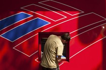 A man using a Bank of America ATM