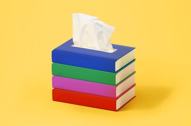 A stack of books with a tissue coming out of the top, like a tissue box.