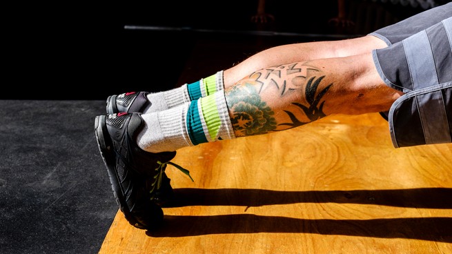 Tattooed legs doing a plank