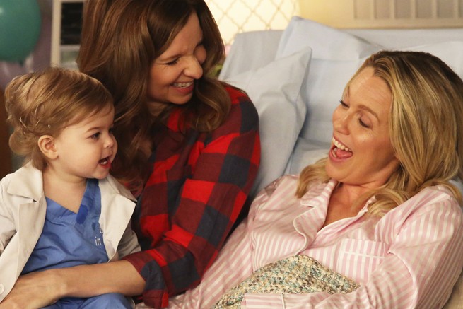 Two women and a toddler smiling at each other in "Playing House"