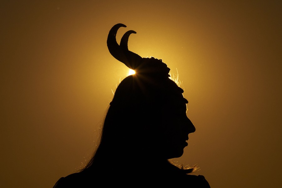 Silhouette of a person wearing horns