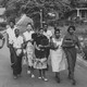 Jo Ann Allen Boyce and nine other Black students walk together down an empty road on their first day of desegregating Clinton High School in Clinton, Tennessee.