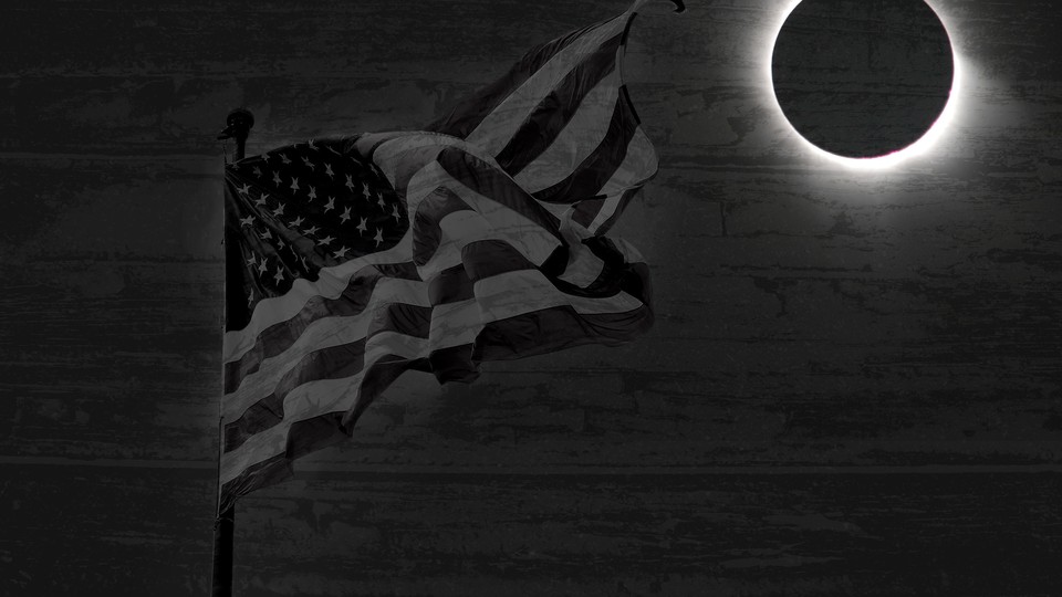 A flag waves in the dark, with a full eclipse in the background
