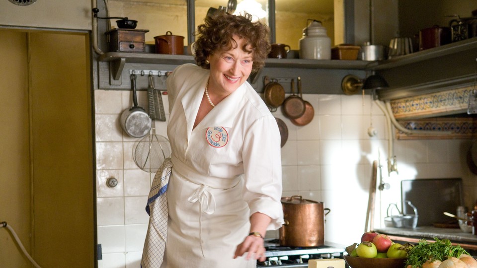 Meryl Streep in a white chef's outfit playing Julia Child