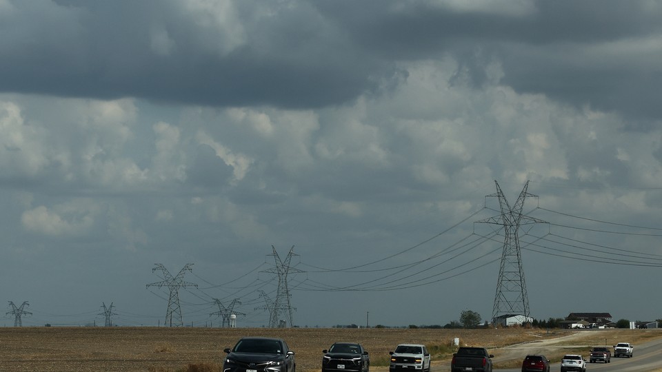 Transmission lines and cars on a road in Texas