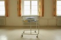 Folded blankets sit atop a cart for newborn babies.