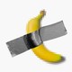 An illustration of a pixelated banana stuck to a white background with duck tape
