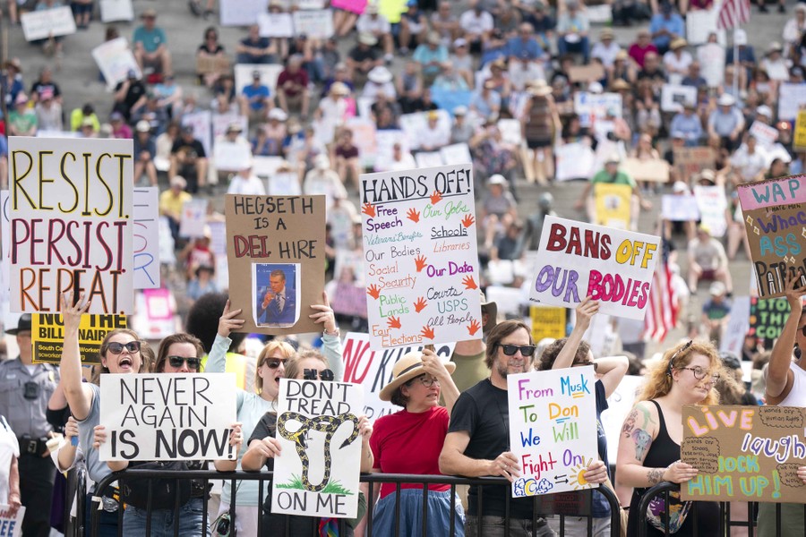 Protesters carry many signs, including one that reads "Bans off our bodies."