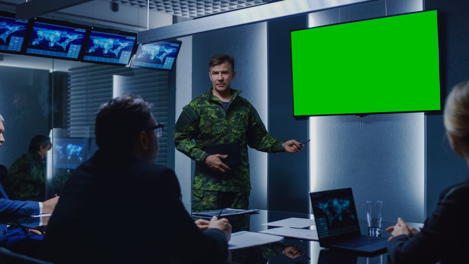 Military briefer points at blank screen
