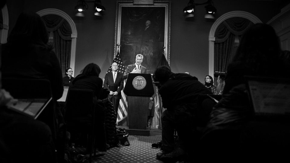 Bill de Blasio speaking from a podium