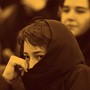 An Iranian student hides her face during a protest against the renewed death sentence of a professor accused of blasphemy, Hashem Aghajari, in 2004 at Tehran University.