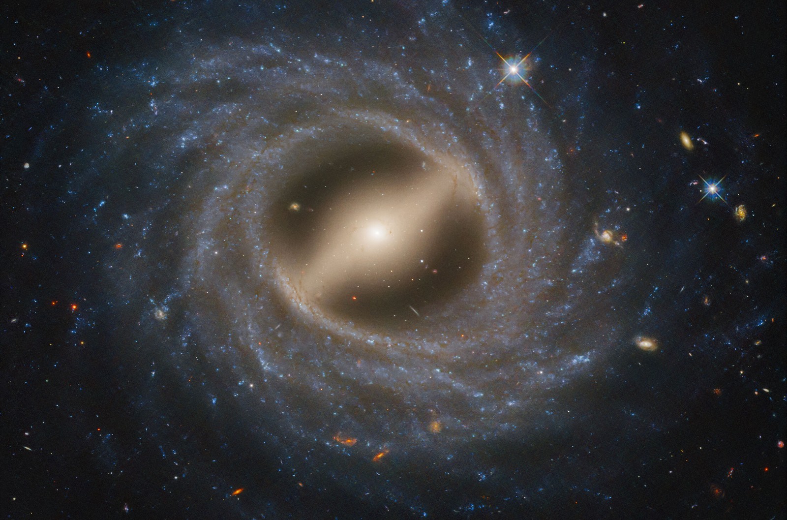 A face-on view of a spiral galaxy, showing a well-defined bar-like structure spanning its center