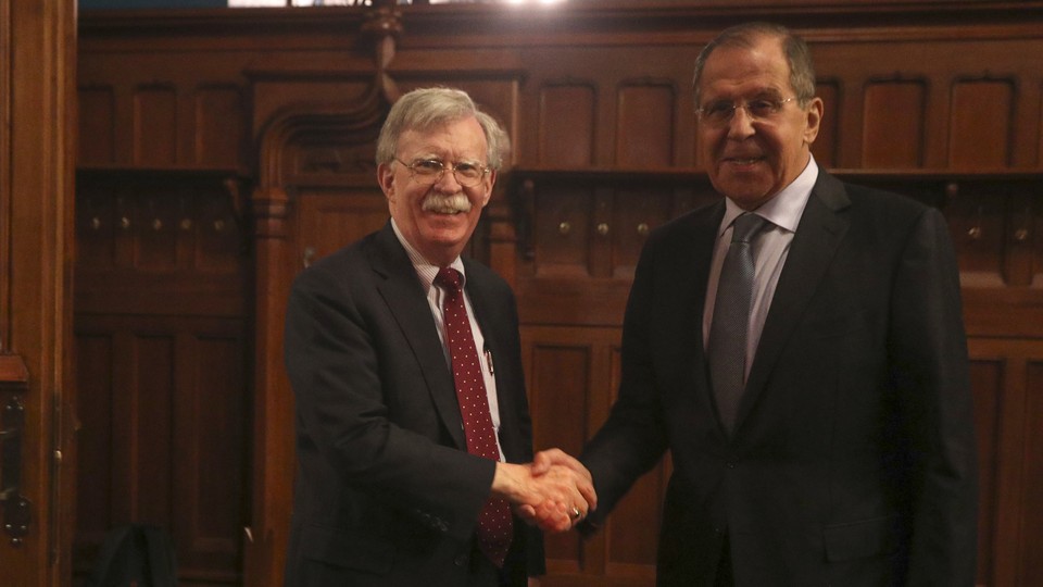 Russian Foreign Minister Sergei Lavrov shakes hands with U.S. National-Security Adviser John Bolton during a meeting in Moscow on October 22, 2018.