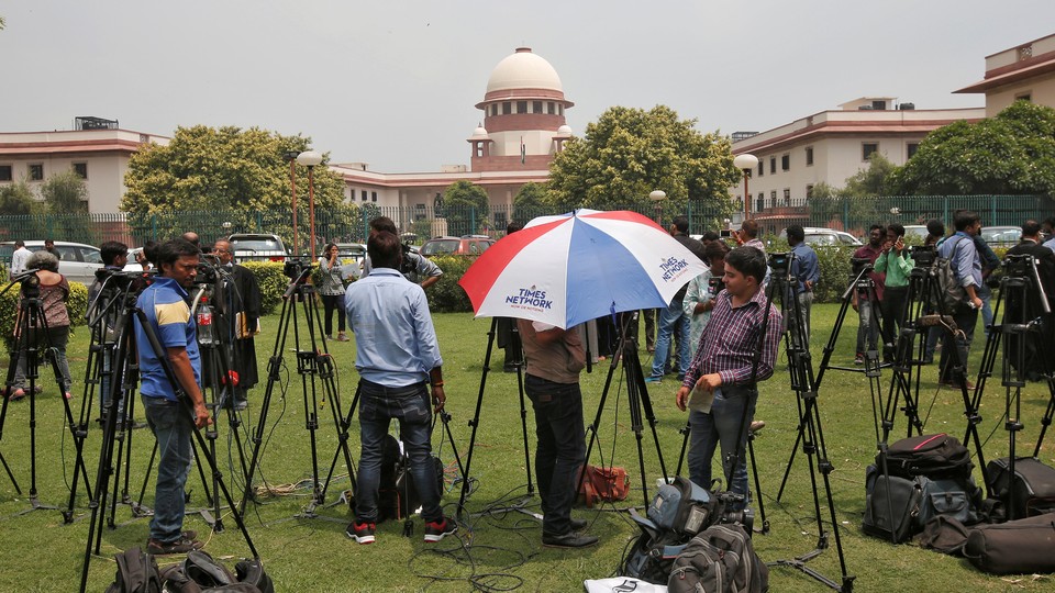 Journalists stand outside India's Supreme Court in New Delhi.