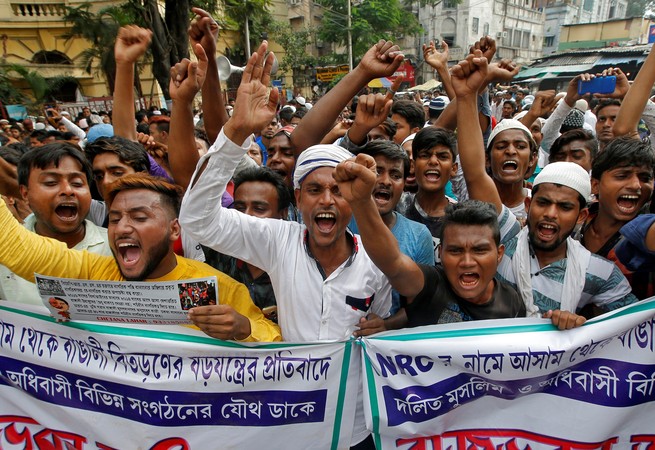 Protesters hold a banner during a demonstration over the NRC in Kolkata.