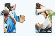 two puzzle pieces in the shape of a house that depict two friends hugging