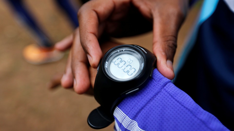 An athlete checking his wristwatch