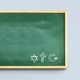 Picture showing green chalkboard with drawings of the Jewish star of David, the Christian cross, and the Muslim star and crescent.