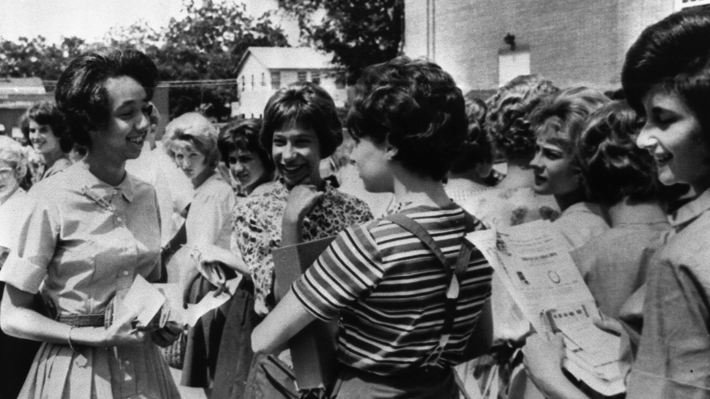 During a bomb scare at the school on September 3, 1963, 15-year-old Millicent Brown, left, chatted with fellow students outside Rivers High School.