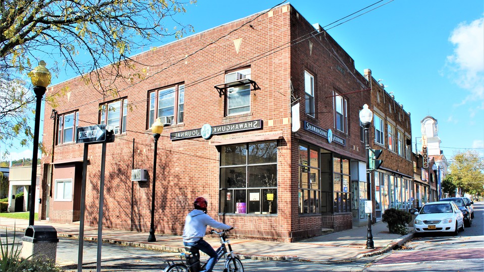The Shawangunk Journal offices in Ellenville, New York. Backwards sign made by artist Roger Baker.