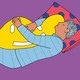 A person sleeping while hugging a pillow shaped like a smiley face