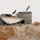 Russian and Syrian national flags are raised above a structure.