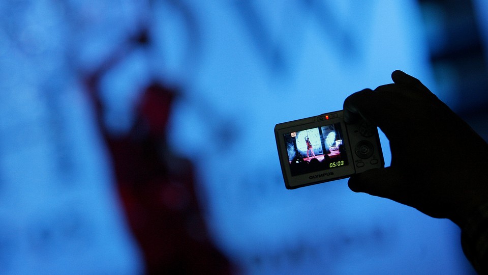 A visitor takes pictures of an adult-film actress in Sofia, Bulgaria, in 2008.