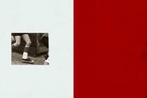A black-and-white, grainy image of a child's legs in motion, on a background that's half beige and half red
