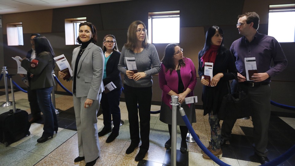 Peruvian citizens applying for U.S. visas wait in line at the American embassy in Lima.