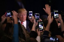 Donald Trump’s supporters take cell phone photographs of him during a February 2016 rally in Reno, Nevada.