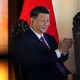 Photo of Xi Jinping sitting in a chair and applauding