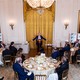 Photograph of Donald Trump speaking at a podium to donors and officials seated at circular dining tables