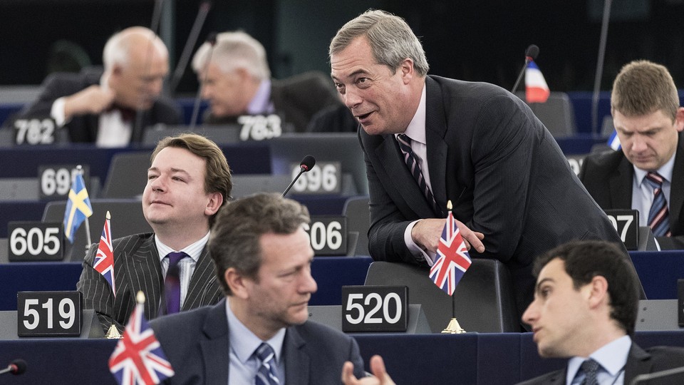 The Brexit supporter Nigel Farage talks with other British MEPs during a European Parliament session in Strasbourg in March.