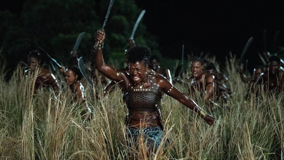 Viola Davis and other woman charging through a field as warriors in "The Woman King"