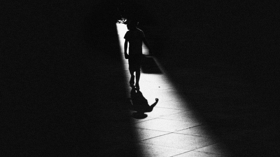Illustration of a little boy walking in darkness, a sliver of light illuminating him