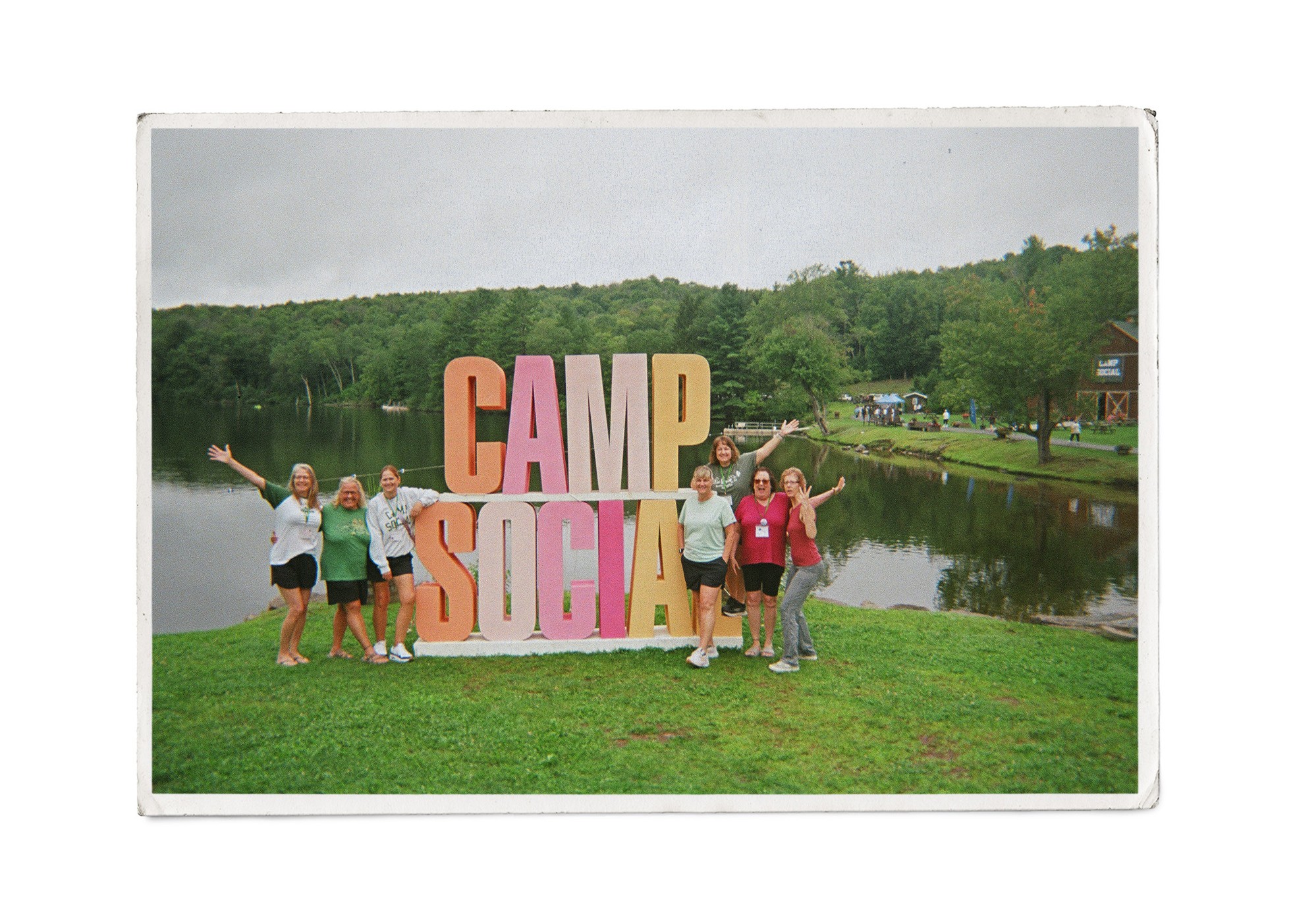 campers stand in front of a sign that says