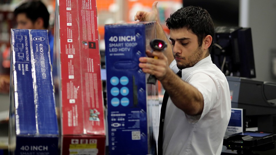 An employee scans televisions on Black Friday.