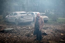 A Ukrainian woman surveys damage caused by a Russian missile in Zaporizhzhya.