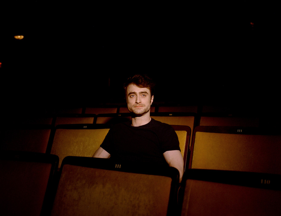 photo of Radcliffe sitting in empty theater